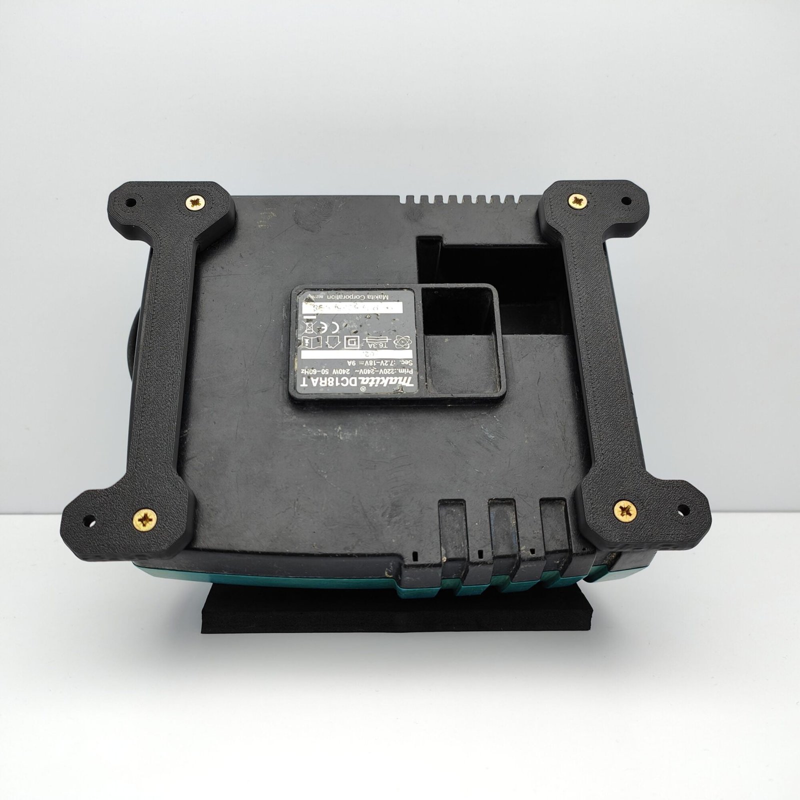 Custom Wall Mount brackets attached to the back of Makita DC18RA Charger