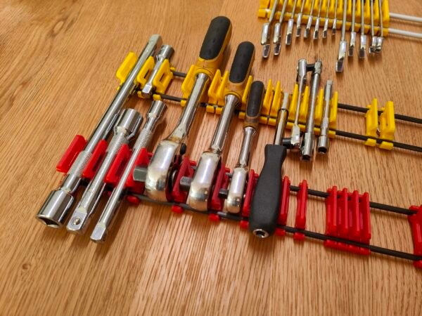 Toolbox drawer organiser for tools with Ratchets extension bars and a screwdriver