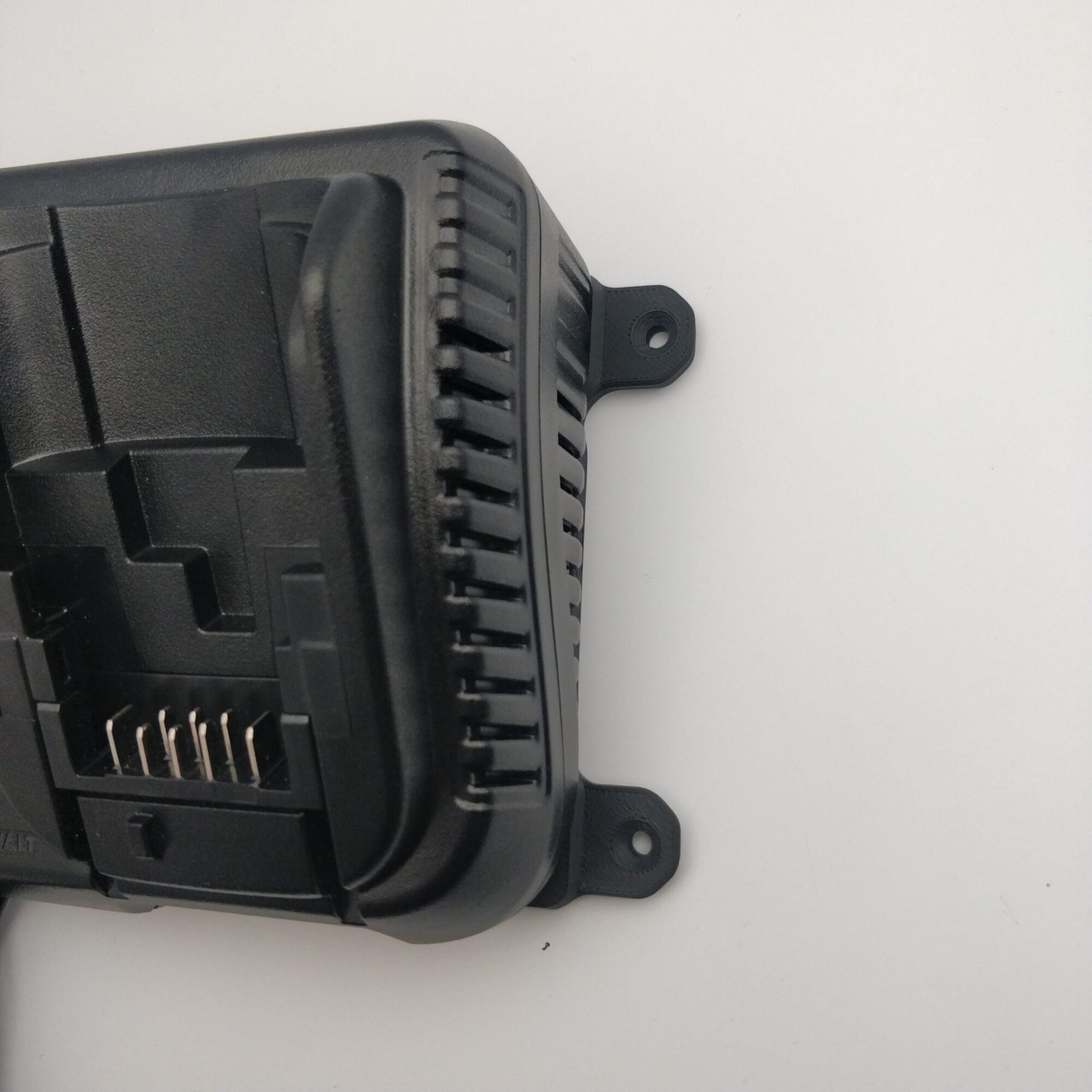 right side of DeWalt DCB115 Charger with wall mount brackets attached